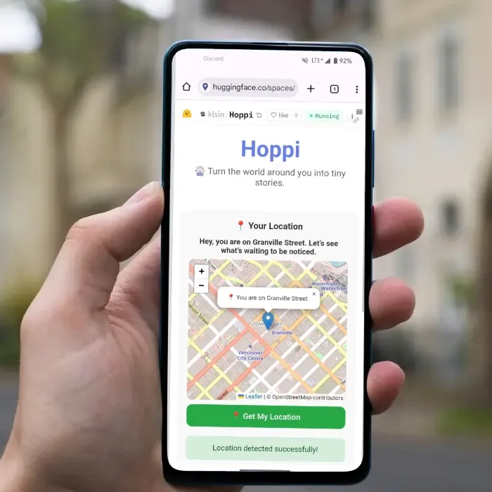 Hand holding a phone showing the Hoppi app